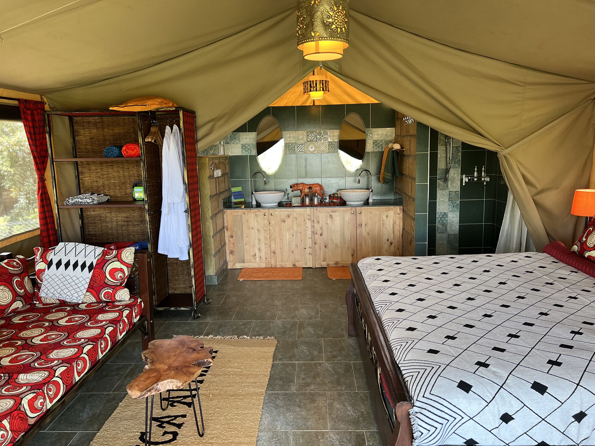 Interior of the second safari tent with a double bed and sofa